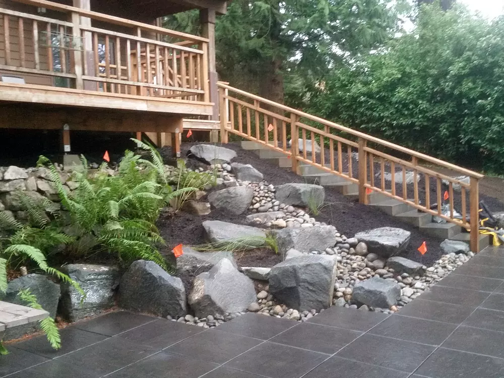 Carpentry Wood Structure: Stylish wooden deck and railing with sophisticated hardscape paver patio
